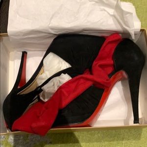 Black suede Christian Louboutin bootie heels.